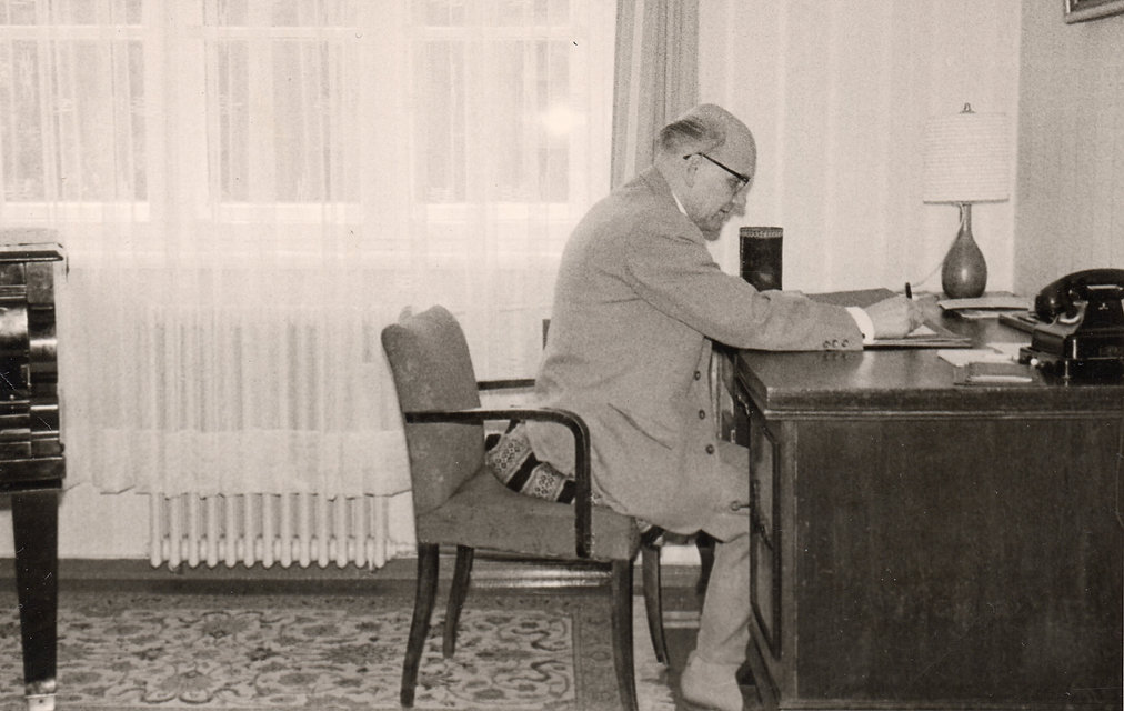 Hermann Neuling seated at a desk