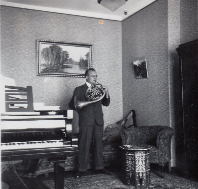 Hermann Neuling playing the horn at home